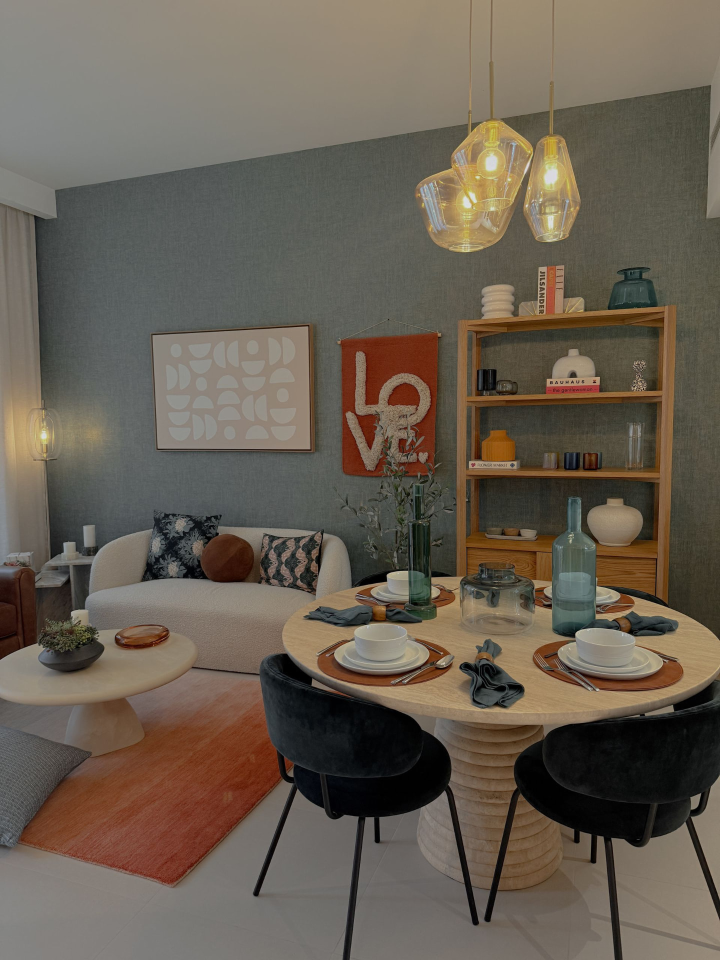 Illustrative shared living and dining area with a round table and soft seating